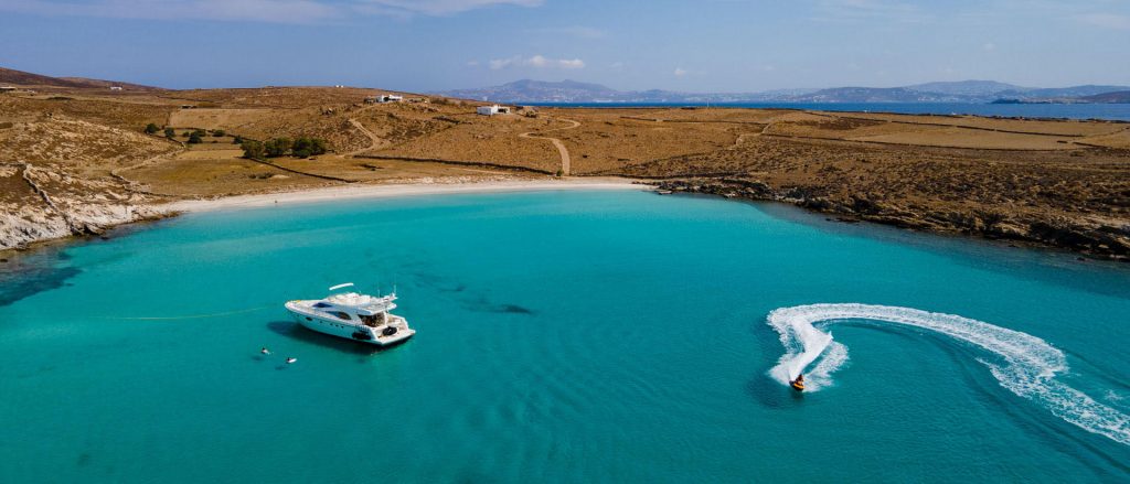 From Mykonos visit the nearby islands of Delos and Rhenia for a cruise combining history and one of the most beautiful locations to enjoy the sea and water sports.